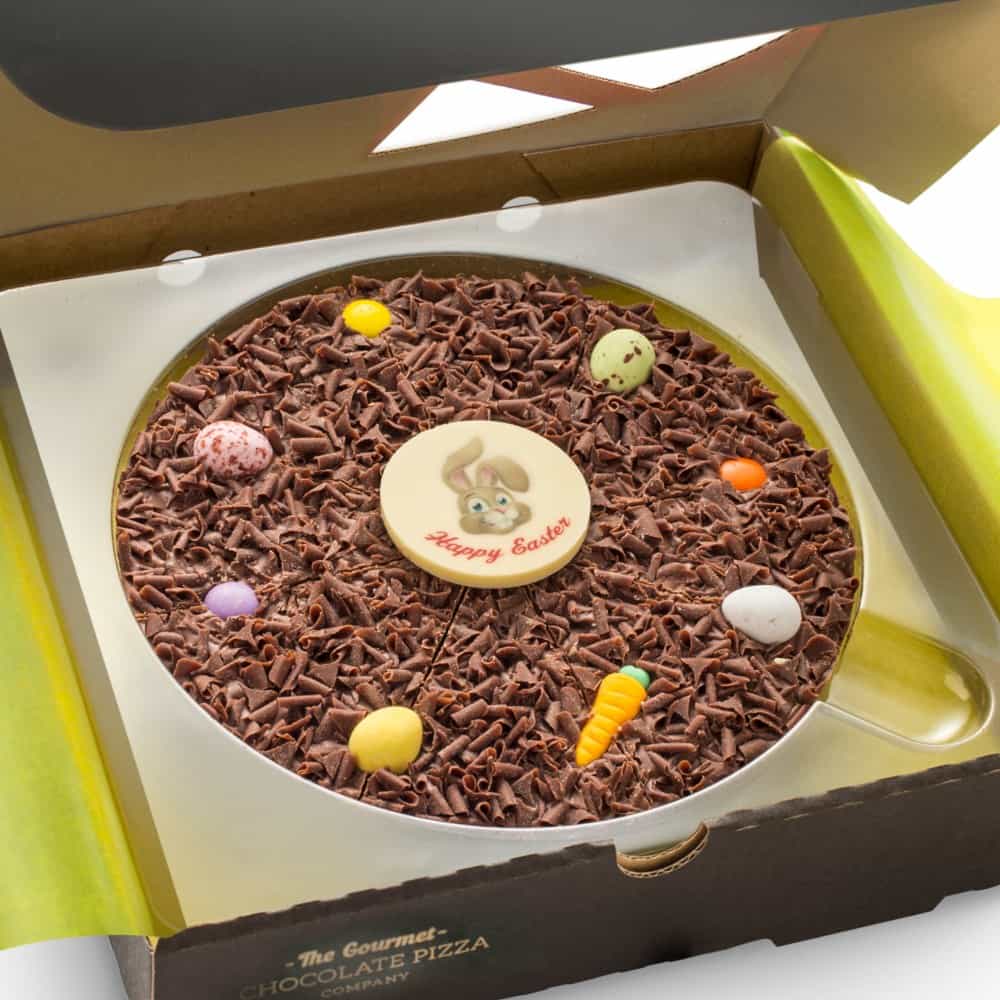 Beautifully decorated with a white chocolate plaque, sugar carrots, and chocolate mini eggs